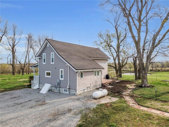 back of property featuring a lawn