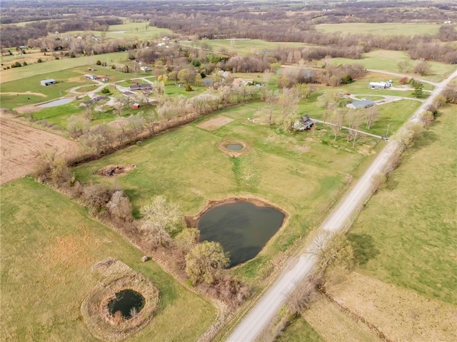 birds eye view of property with a water view and a rural view