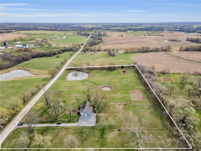 drone / aerial view with a water view and a rural view