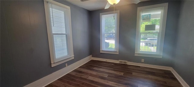 224 Spruce St, Leavenworth, KS 66048 - empty room with a wealth of natural light, baseboards, dark wood finished floors, and a ceiling fan