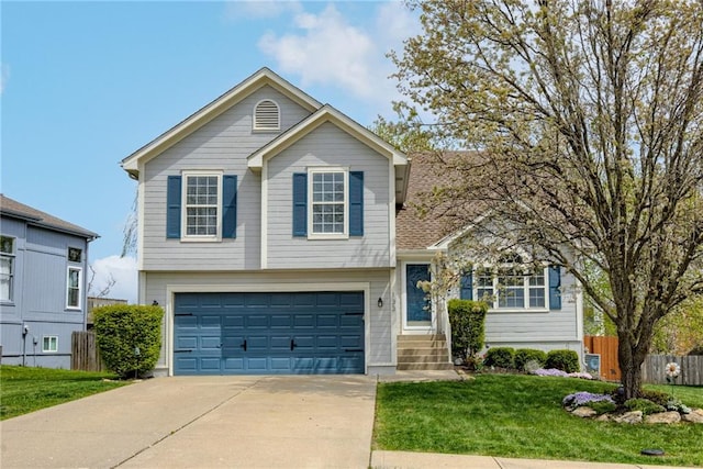 tri-level home with concrete driveway, a front yard, fence, and an attached garage