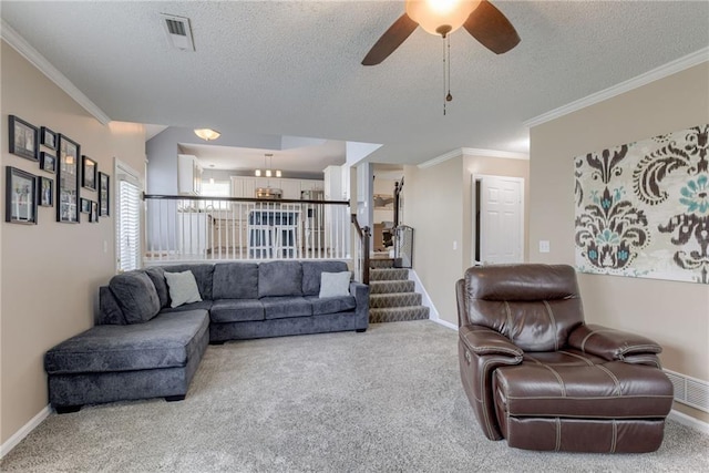 living area with carpet flooring, visible vents, and a textured ceiling