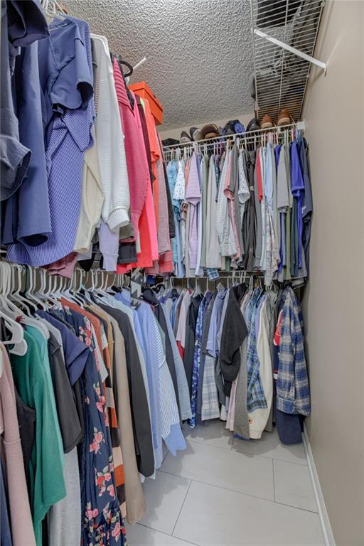 spacious closet with tile patterned floors