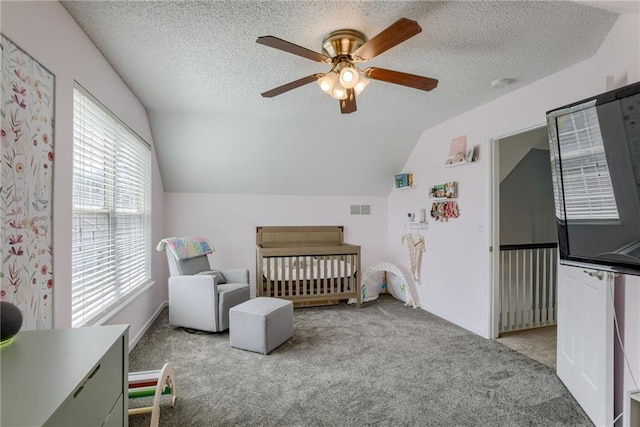 bedroom featuring a textured ceiling, lofted ceiling, visible vents, and carpet floors