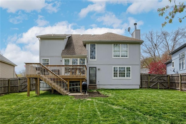 back of house featuring a lawn, a chimney, a fenced backyard, stairway, and a wooden deck