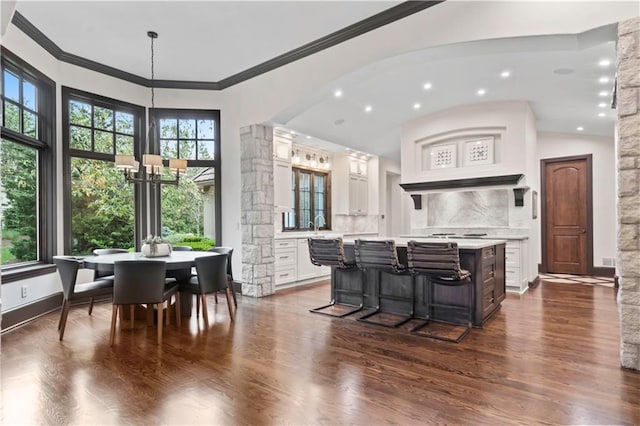 10408 Howe Ln, Leawood, KS 66206 - interior space with an inviting chandelier, dark wood-style flooring, a center island, light countertops, and white cabinets