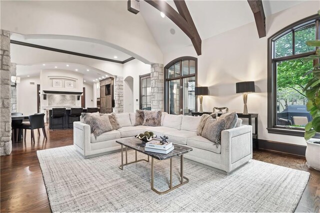 10408 Howe Ln, Leawood, KS 66206 - living room with decorative columns, arched walkways, wood finished floors, high vaulted ceiling, and recessed lighting