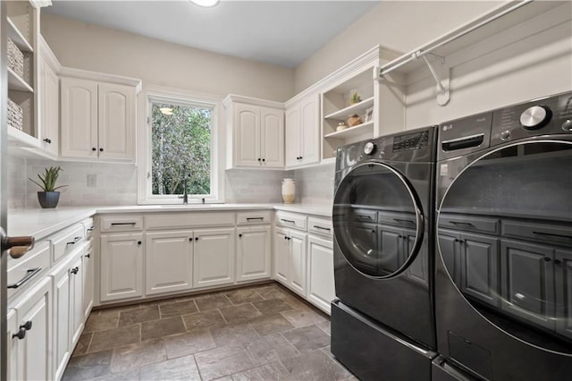 10408 Howe Ln, Leawood, KS 66206 - clothes washing area with independent washer and dryer, stone finish floor, a sink, and cabinet space