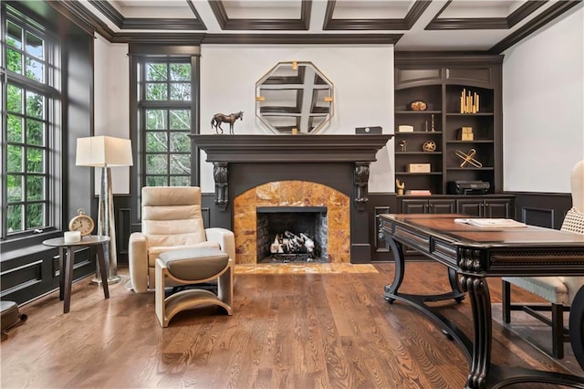 10408 Howe Ln, Leawood, KS 66206 - sitting room featuring a high end fireplace, crown molding, beam ceiling, wood finished floors, and coffered ceiling