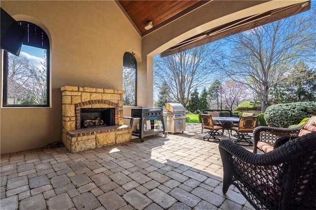 10408 Howe Ln, Leawood, KS 66206 - view of patio featuring outdoor dining area, area for grilling, and an outdoor stone fireplace