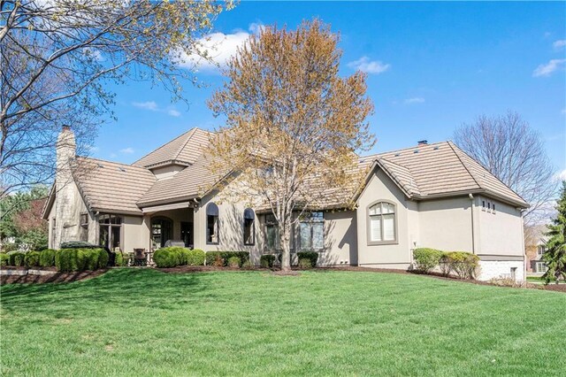 10408 Howe Ln, Leawood, KS 66206 - rear view of property featuring a lawn, a chimney, and stucco siding