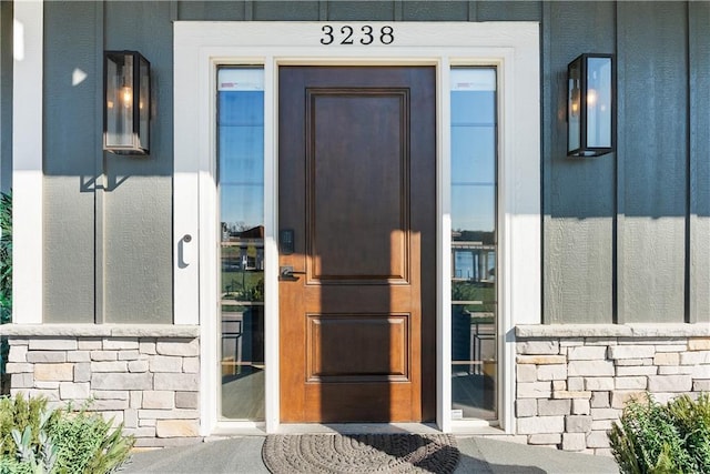 entrance to property featuring stone siding