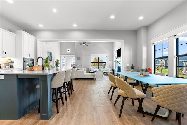 dining room with recessed lighting, light wood-type flooring, and ceiling fan