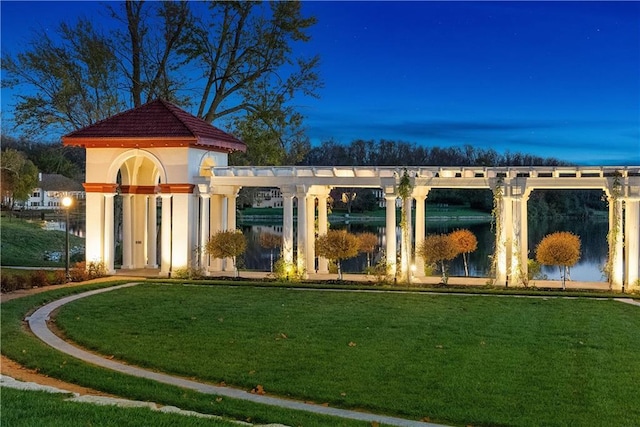exterior space featuring a lawn and a water view