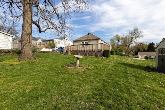 view of yard with a residential view and a deck