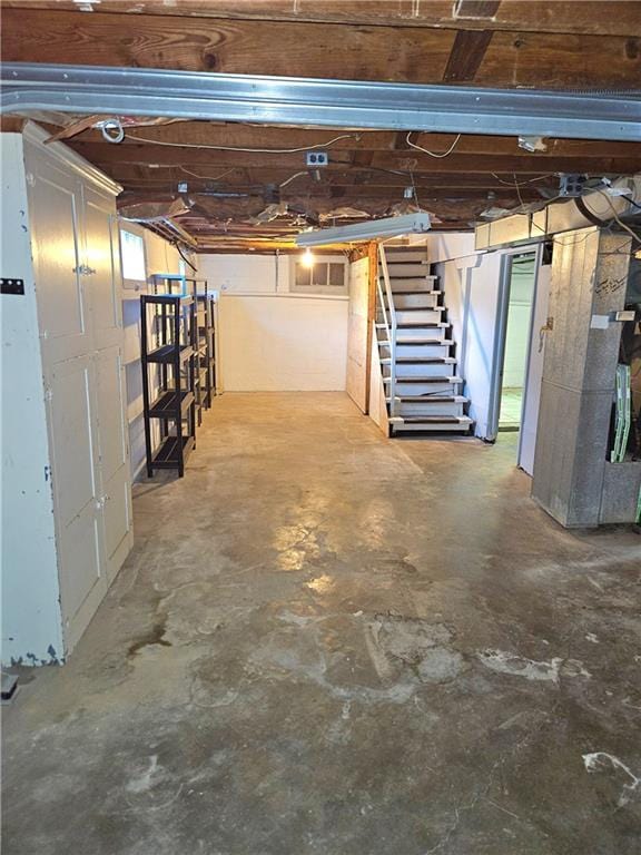 unfinished below grade area featuring stairway