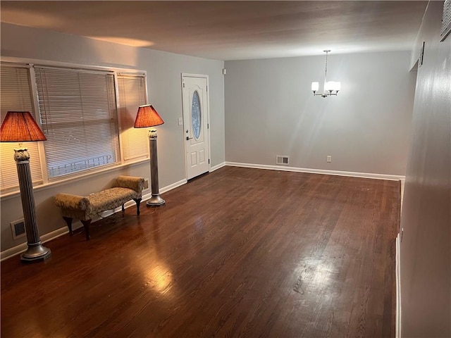 entrance foyer featuring visible vents, baseboards, and wood finished floors