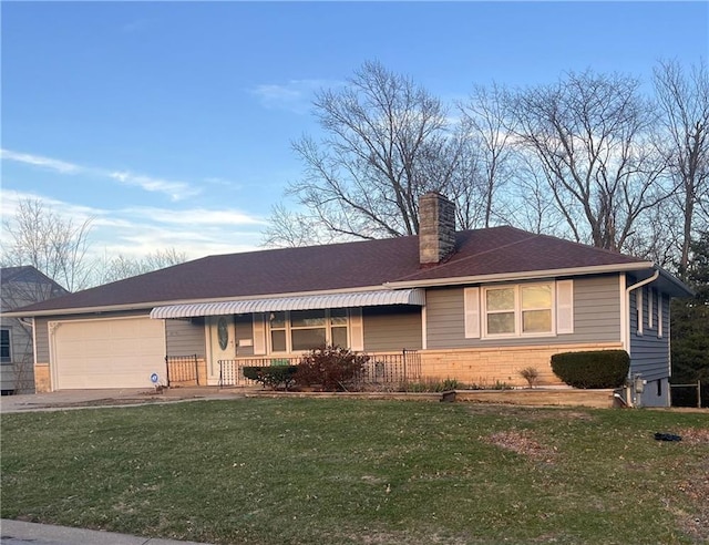 single story home with an attached garage, a chimney, driveway, and a front lawn
