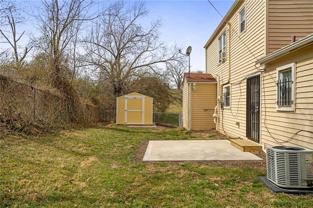 4001 E 55th St, Kansas City, MO 64130 - view of yard featuring a storage unit, an outbuilding, central AC unit, fence, and a patio area