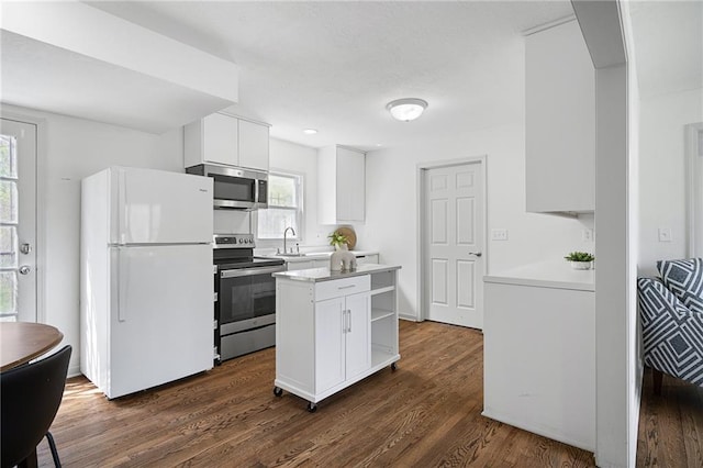 4001 E 55th St, Kansas City, MO 64130 - kitchen featuring open shelves, light countertops, white cabinets, appliances with stainless steel finishes, and dark wood-style floors
