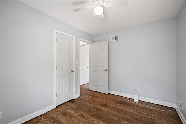 4001 E 55th St, Kansas City, MO 64130 - unfurnished bedroom featuring baseboards, wood finished floors, visible vents, and a ceiling fan