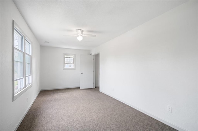 4001 E 55th St, Kansas City, MO 64130 - carpeted spare room featuring baseboards and ceiling fan