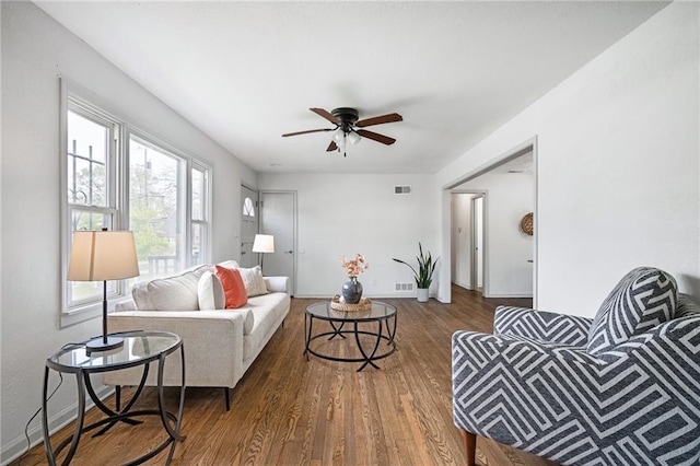 4001 E 55th St, Kansas City, MO 64130 - living room featuring baseboards, a ceiling fan, wood finished floors, and visible vents
