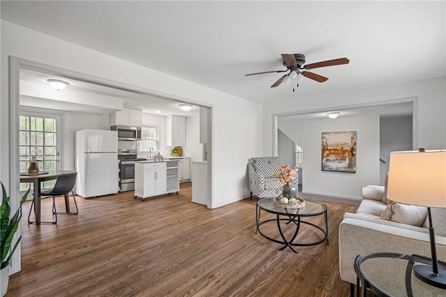 4001 E 55th St, Kansas City, MO 64130 - living area featuring a ceiling fan, baseboards, and dark wood-style flooring