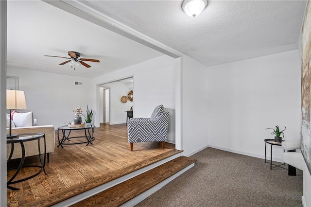 4001 E 55th St, Kansas City, MO 64130 - sitting room with a textured ceiling, carpet floors, visible vents, and a ceiling fan