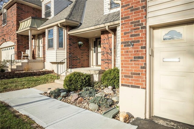 327 E Partridge Ave, Independence, MO 64055 - entrance to property with a garage, brick siding, and roof with shingles