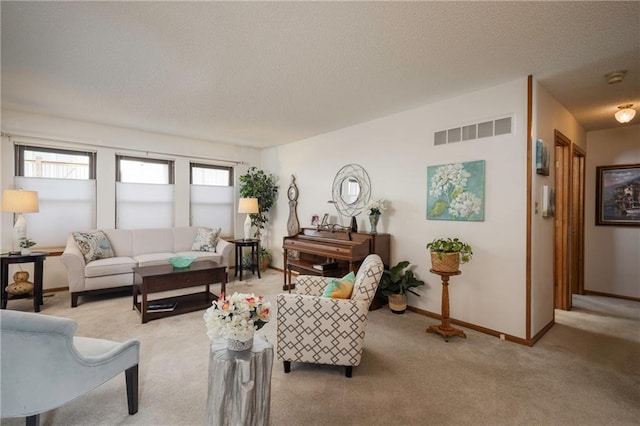 327 E Partridge Ave, Independence, MO 64055 - living room with light carpet, visible vents, a textured ceiling, and baseboards
