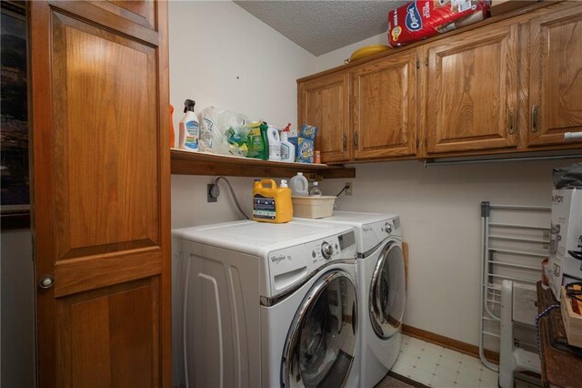 327 E Partridge Ave, Independence, MO 64055 - laundry room with washing machine and clothes dryer, baseboards, light floors, cabinet space, and a textured ceiling