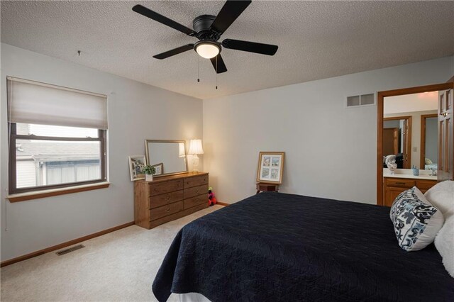 327 E Partridge Ave, Independence, MO 64055 - bedroom featuring visible vents, light colored carpet, a textured ceiling, and baseboards