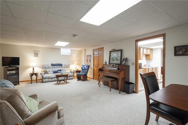 327 E Partridge Ave, Independence, MO 64055 - living room with a paneled ceiling, baseboards, and carpet