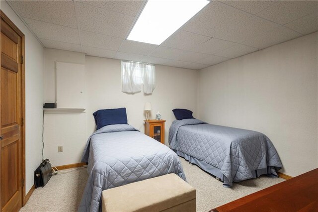 327 E Partridge Ave, Independence, MO 64055 - bedroom featuring baseboards, a paneled ceiling, and carpet flooring