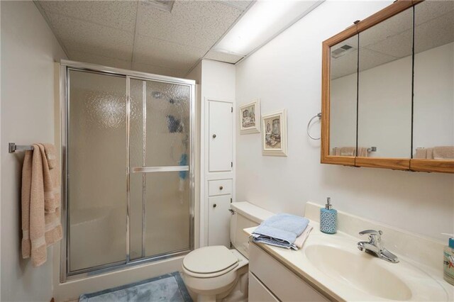 327 E Partridge Ave, Independence, MO 64055 - full bath with vanity, visible vents, a stall shower, a paneled ceiling, and toilet
