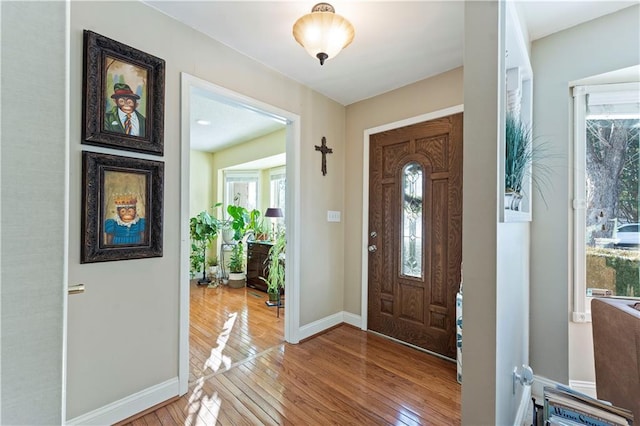foyer entrance with baseboards and hardwood / wood-style flooring