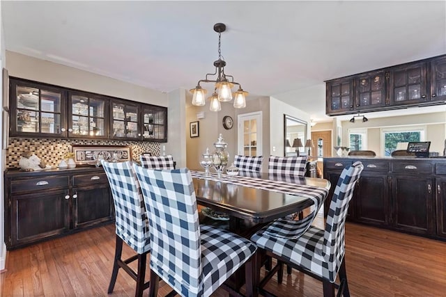 dining room featuring dark wood-style flooring and an inviting chandelier
