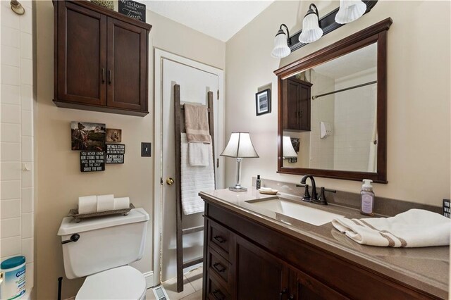 full bathroom with toilet, baseboards, walk in shower, and vanity