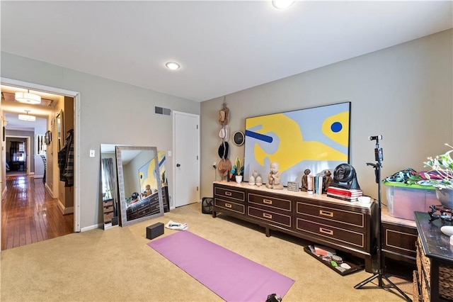 exercise area with visible vents and carpet