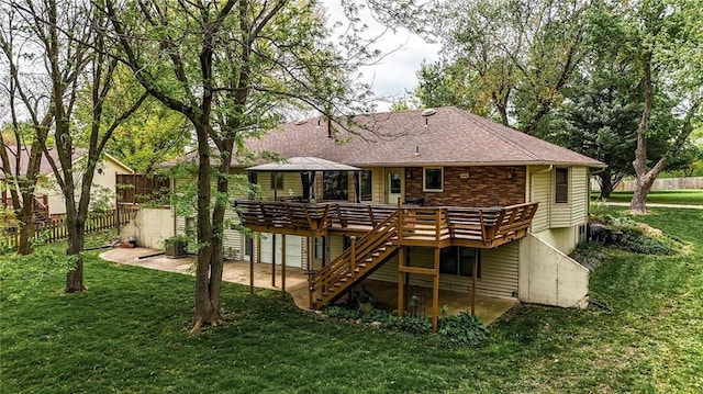 back of house featuring fence, stairs, a yard, and a deck