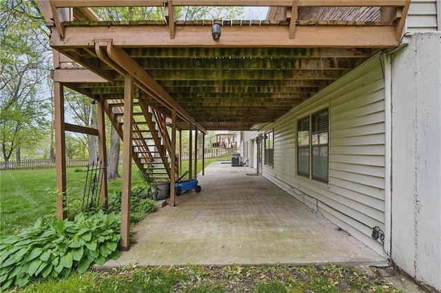 view of patio featuring stairs, central AC, and fence