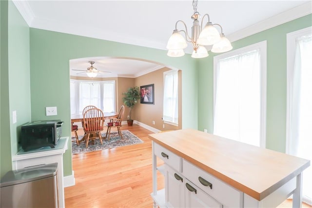 4373 Hackberry Ln, Bates City, MO 64011 - kitchen with arched walkways, crown molding, light wood-style flooring, a chandelier, and white cabinets
