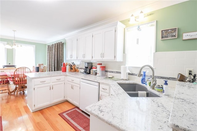 4373 Hackberry Ln, Bates City, MO 64011 - kitchen with white dishwasher, a peninsula, a sink, and white cabinets