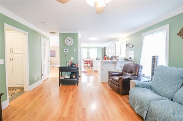 4373 Hackberry Ln, Bates City, MO 64011 - living area featuring crown molding, light wood-style flooring, a ceiling fan, and baseboards