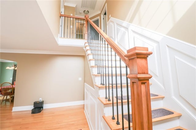 4373 Hackberry Ln, Bates City, MO 64011 - staircase with wood finished floors, ornamental molding, a towering ceiling, and arched walkways