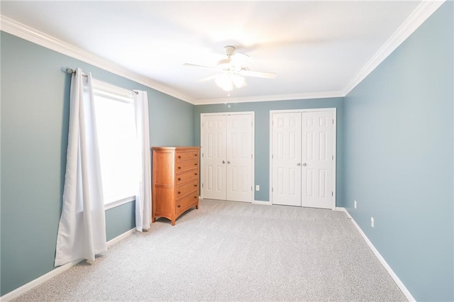 4373 Hackberry Ln, Bates City, MO 64011 - unfurnished bedroom with multiple closets, crown molding, carpet flooring, baseboards, and ceiling fan