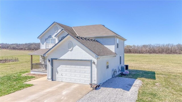 4373 Hackberry Ln, Bates City, MO 64011 - view of home's exterior featuring an attached garage, driveway, a lawn, and central AC unit