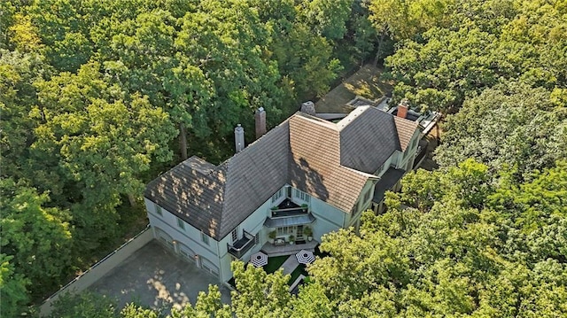 drone / aerial view featuring a wooded view