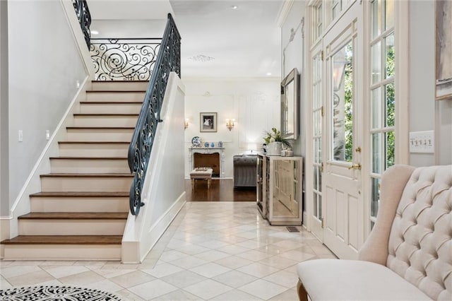 stairs featuring tile patterned floors, recessed lighting, and a wealth of natural light